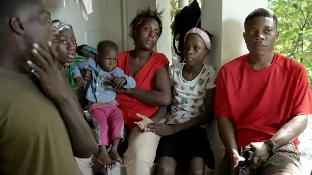 Negociant (centro) ahora vive con su familia en un campamento para personas desplazadas.
